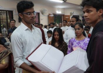 Two Bibles handwritten by parishioners in India